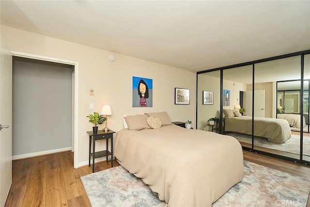 bedroom with hardwood / wood-style flooring and a closet