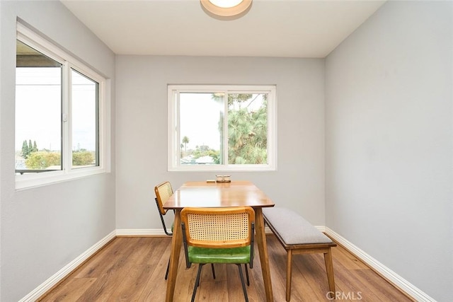 dining space with wood-type flooring