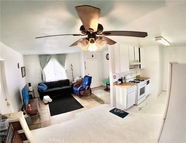 kitchen with white cabinetry, ceiling fan, and white appliances