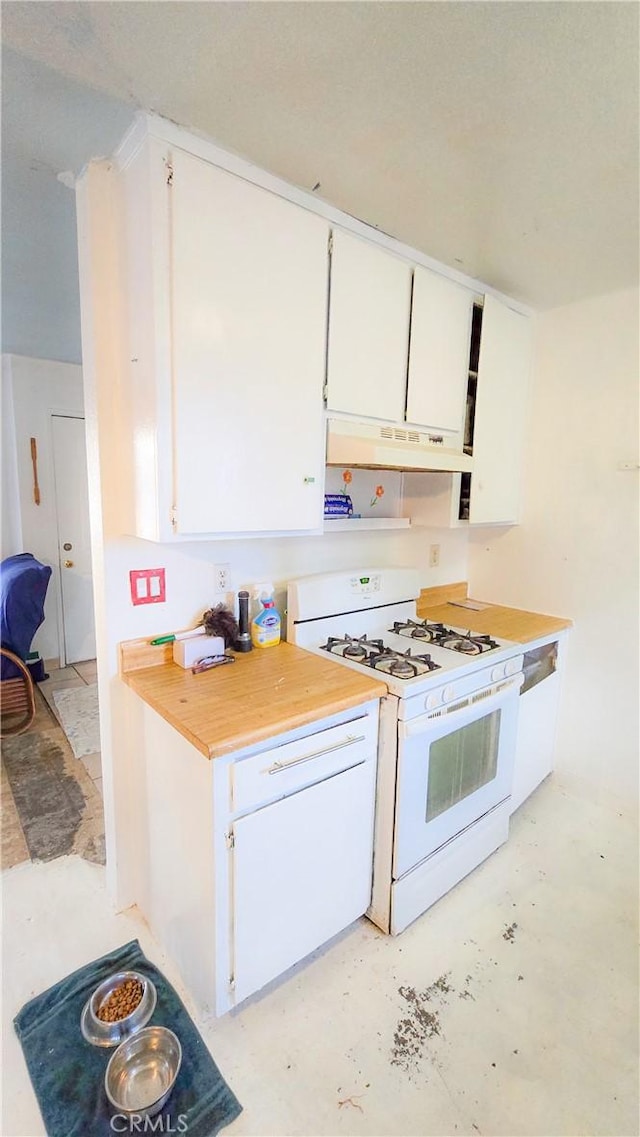 kitchen with white gas range and white cabinets