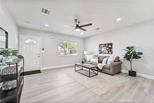 living room featuring ceiling fan and light hardwood / wood-style floors