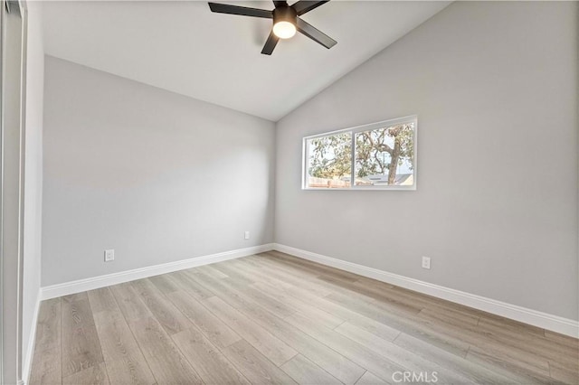 spare room with lofted ceiling, ceiling fan, and light hardwood / wood-style flooring