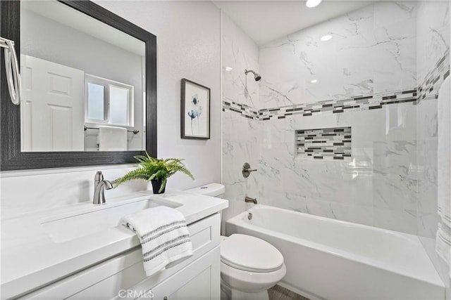 full bathroom with vanity, toilet, and tiled shower / bath combo