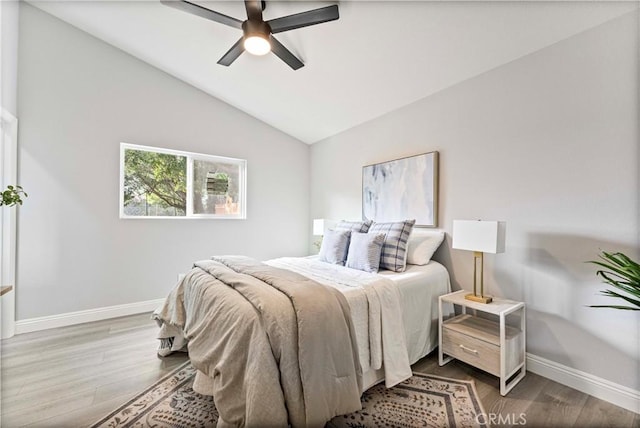 bedroom featuring lofted ceiling, hardwood / wood-style flooring, and ceiling fan