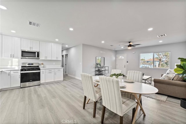 dining room with ceiling fan and light hardwood / wood-style flooring