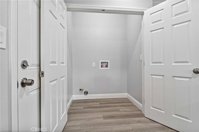 laundry area with hookup for a washing machine and light wood-type flooring