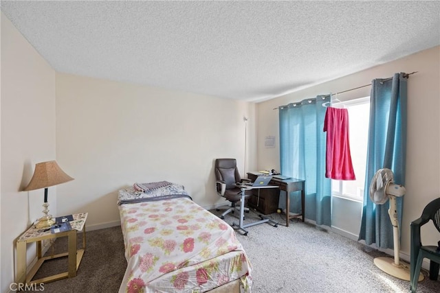 bedroom with multiple windows, carpet floors, and a textured ceiling