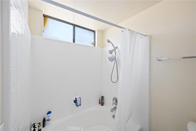 bathroom featuring shower / bathtub combination with curtain