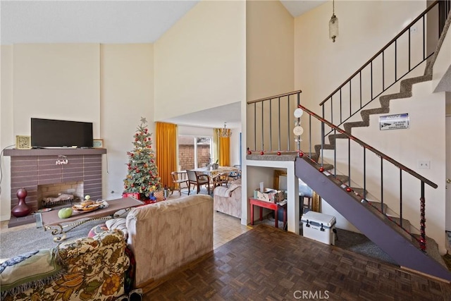 living room featuring a high ceiling, parquet floors, and a fireplace