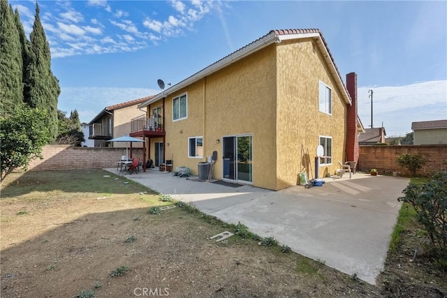 back of property featuring a patio area, a balcony, and central air condition unit