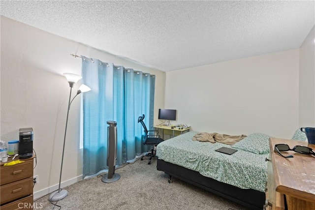 bedroom with carpet and a textured ceiling