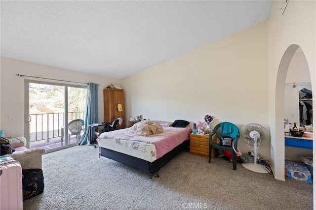 carpeted bedroom with access to exterior and vaulted ceiling