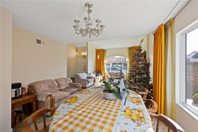 living room featuring plenty of natural light and a notable chandelier