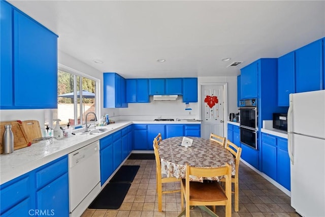 kitchen with blue cabinets, sink, light tile patterned floors, and black appliances