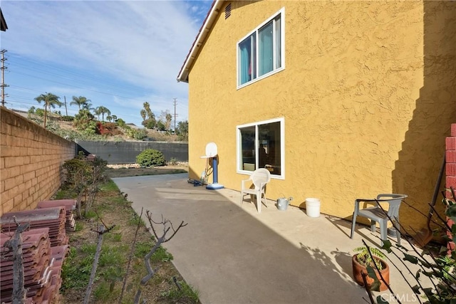 view of side of property with a patio area