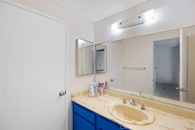 bathroom featuring vanity and a textured ceiling