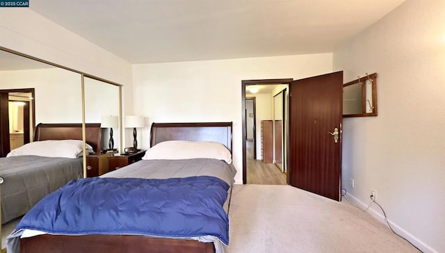 bedroom featuring light colored carpet and a closet