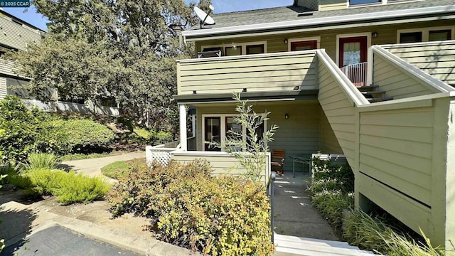 view of exterior entry featuring a balcony