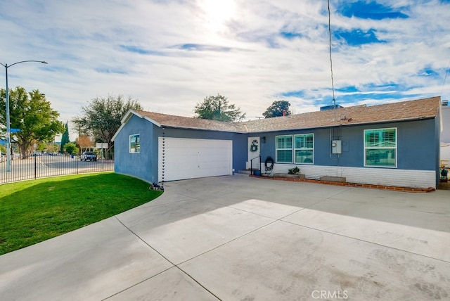 ranch-style home featuring a garage and a front yard