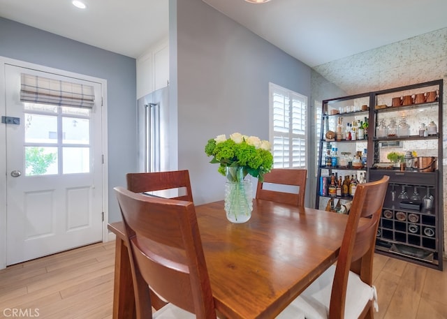 dining space with light hardwood / wood-style floors