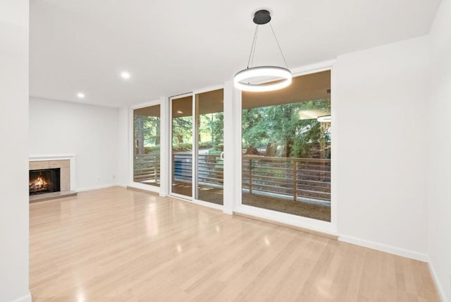 interior space with floor to ceiling windows and light wood-type flooring