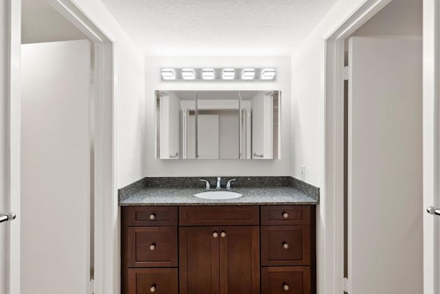 bathroom featuring vanity and a textured ceiling