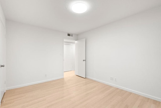 spare room with light hardwood / wood-style flooring