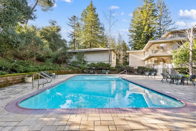 view of swimming pool with a patio