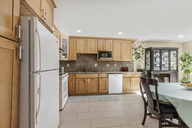 kitchen featuring tasteful backsplash, sink, and white appliances