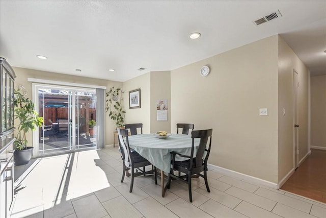 dining area featuring light tile patterned flooring