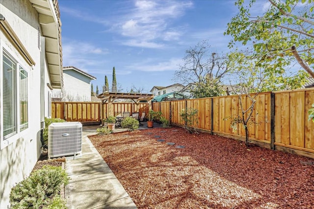 view of yard featuring a pergola, cooling unit, and a patio area