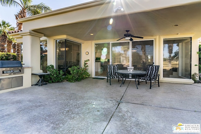 view of patio / terrace with area for grilling, ceiling fan, and an outdoor kitchen