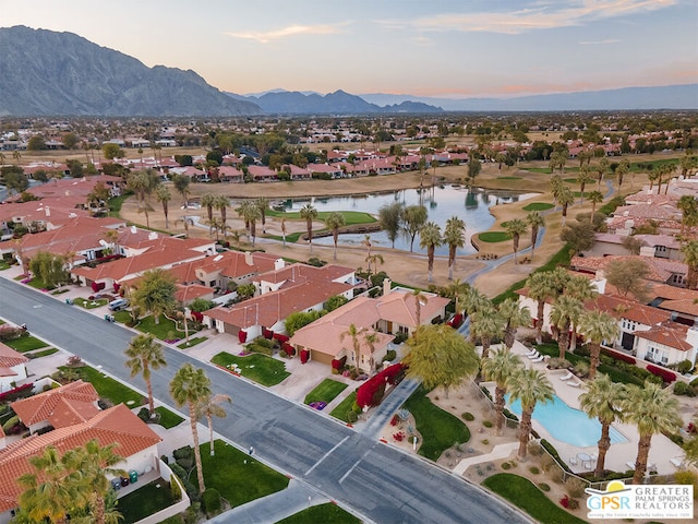 aerial view at dusk with a water and mountain view