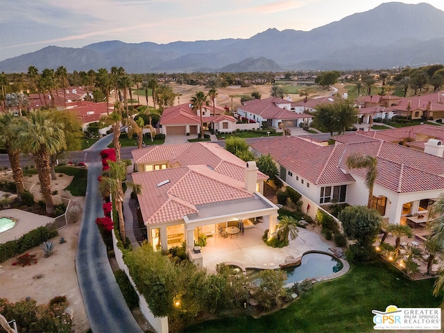 birds eye view of property with a mountain view