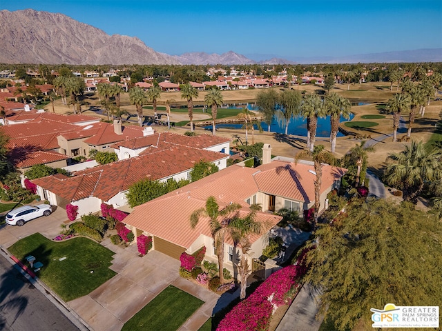 drone / aerial view with a water and mountain view