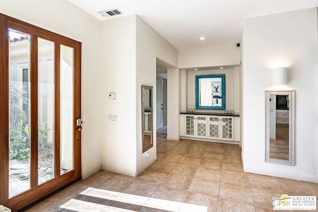 foyer featuring light tile patterned floors