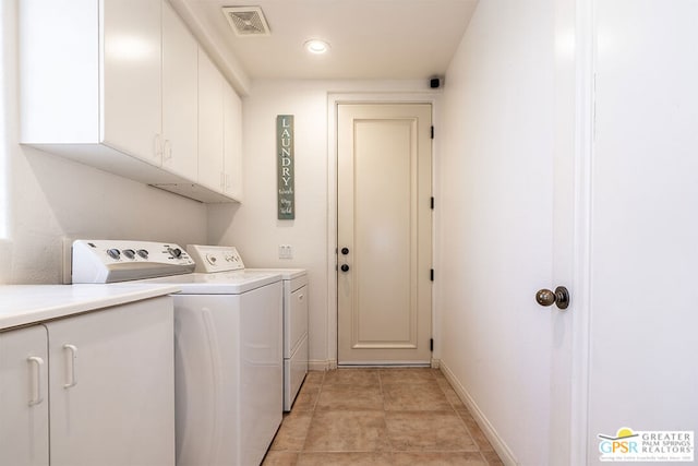 laundry area with cabinets, separate washer and dryer, and light tile patterned floors