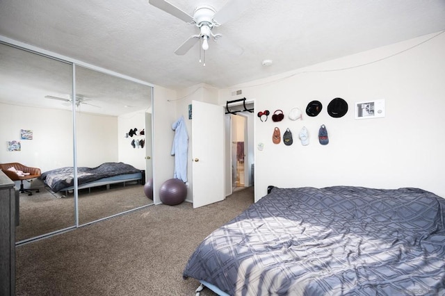 carpeted bedroom featuring ceiling fan and a closet