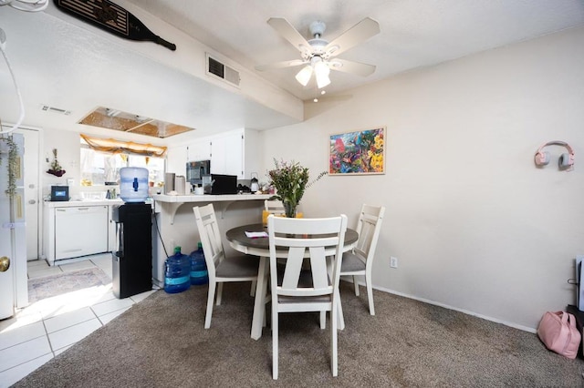 tiled dining area with ceiling fan