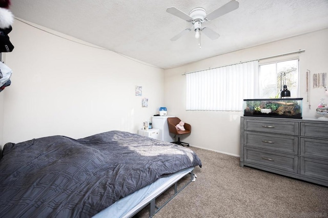 carpeted bedroom with a textured ceiling and ceiling fan