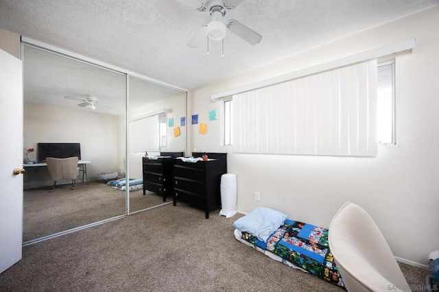 interior space featuring ceiling fan, a closet, and a textured ceiling