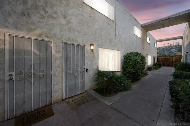 view of exterior entry at dusk