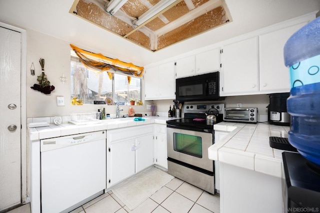 kitchen with white cabinets, white dishwasher, tile countertops, and electric range