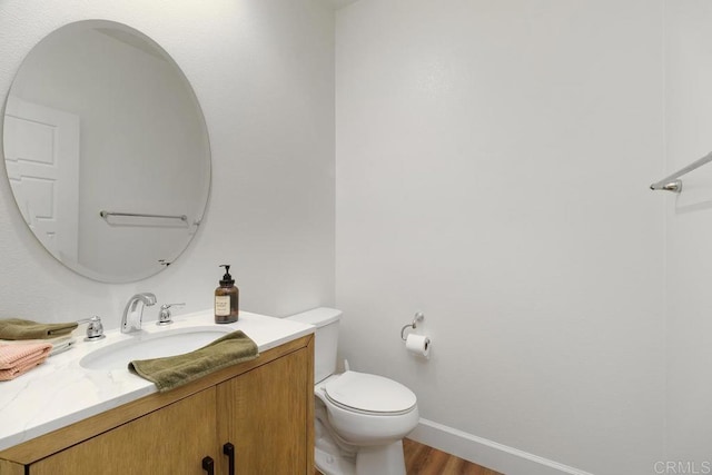 bathroom featuring hardwood / wood-style flooring, vanity, and toilet