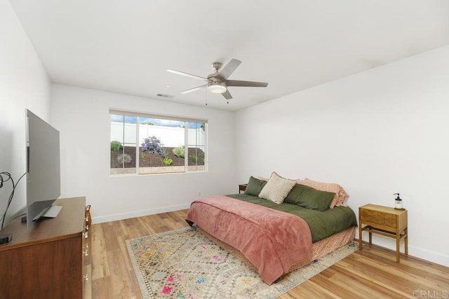 bedroom with ceiling fan and light hardwood / wood-style flooring