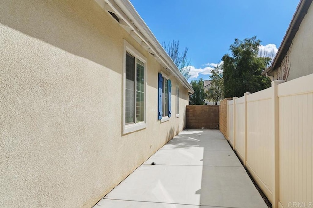 view of side of property featuring a patio area