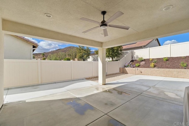 view of patio with a mountain view and ceiling fan