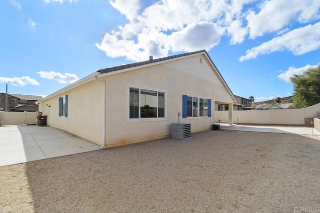 back of house with a patio and central AC unit