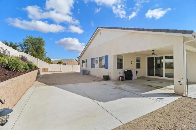 back of house with cooling unit, a patio area, and ceiling fan