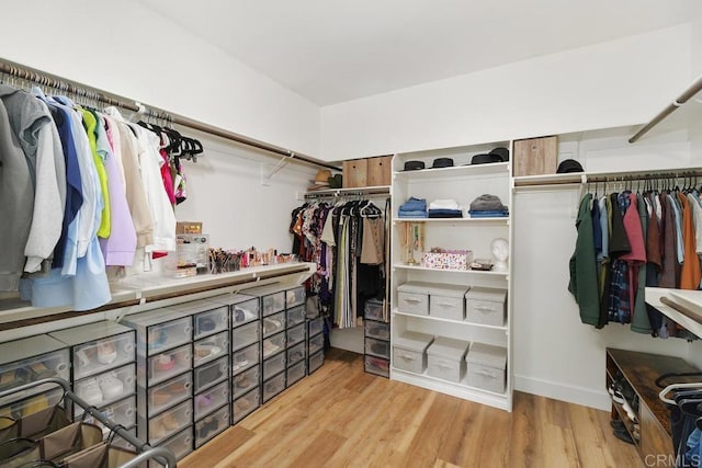 spacious closet with light hardwood / wood-style floors